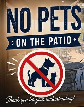Sign displaying No Pets On The Patio with a red prohibition symbol showing a dog and cat crossed out, and text reading Thank you for your understanding